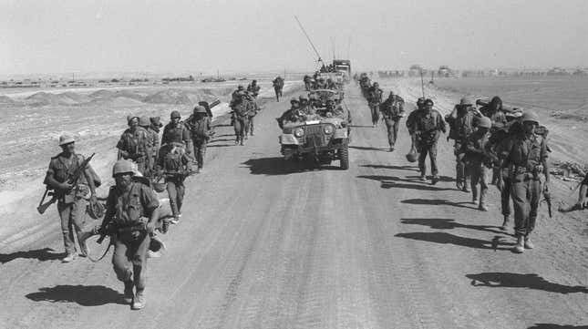 Israeli paratroopers march October 25, 1973 along the Suez-Cairo road on the western bank of the Suez Canal during the Yom Kippur War.