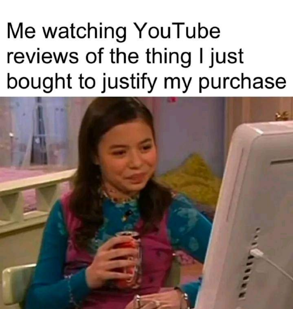 Person holding a drink, sitting at a computer, with text: "Me watching YouTube reviews of the thing I just bought to justify my purchase."