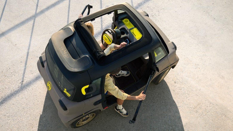 overhead view of an Ami Buggy with its roof retracted and doors open with people stepping out