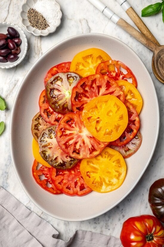 Overhead view of sliced heirloom tomatoes on platter