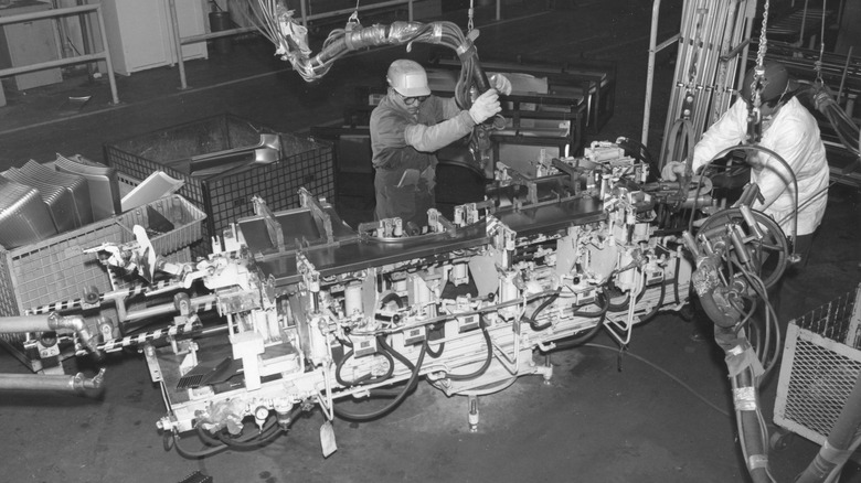 A photo of the employees manufacturing a part inside the Toyota Motor Manufacturing U.S.A. Inc. in 1980
