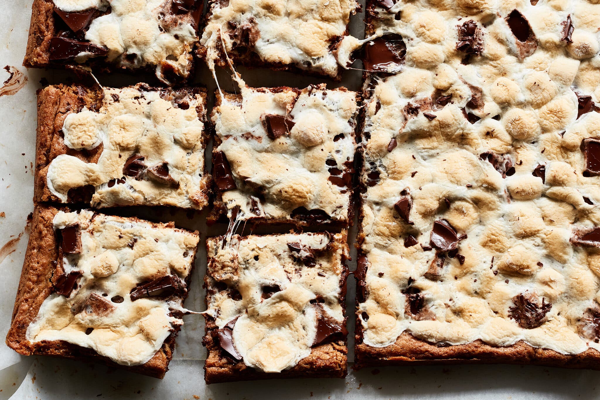 An overhead image of marshmallow topped blondies that have been cut into squares.