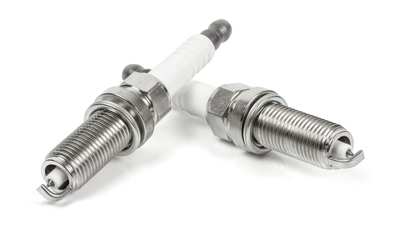 Two iridium spark plugs on a white background.