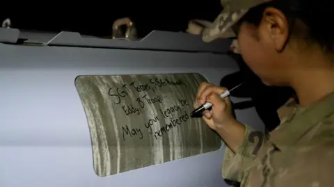 US Air Force/Reuters A soldier signs a bomb: "Sgt Torres, Sgt Howard, Eddy, B Troop... May your legacy be remembered"