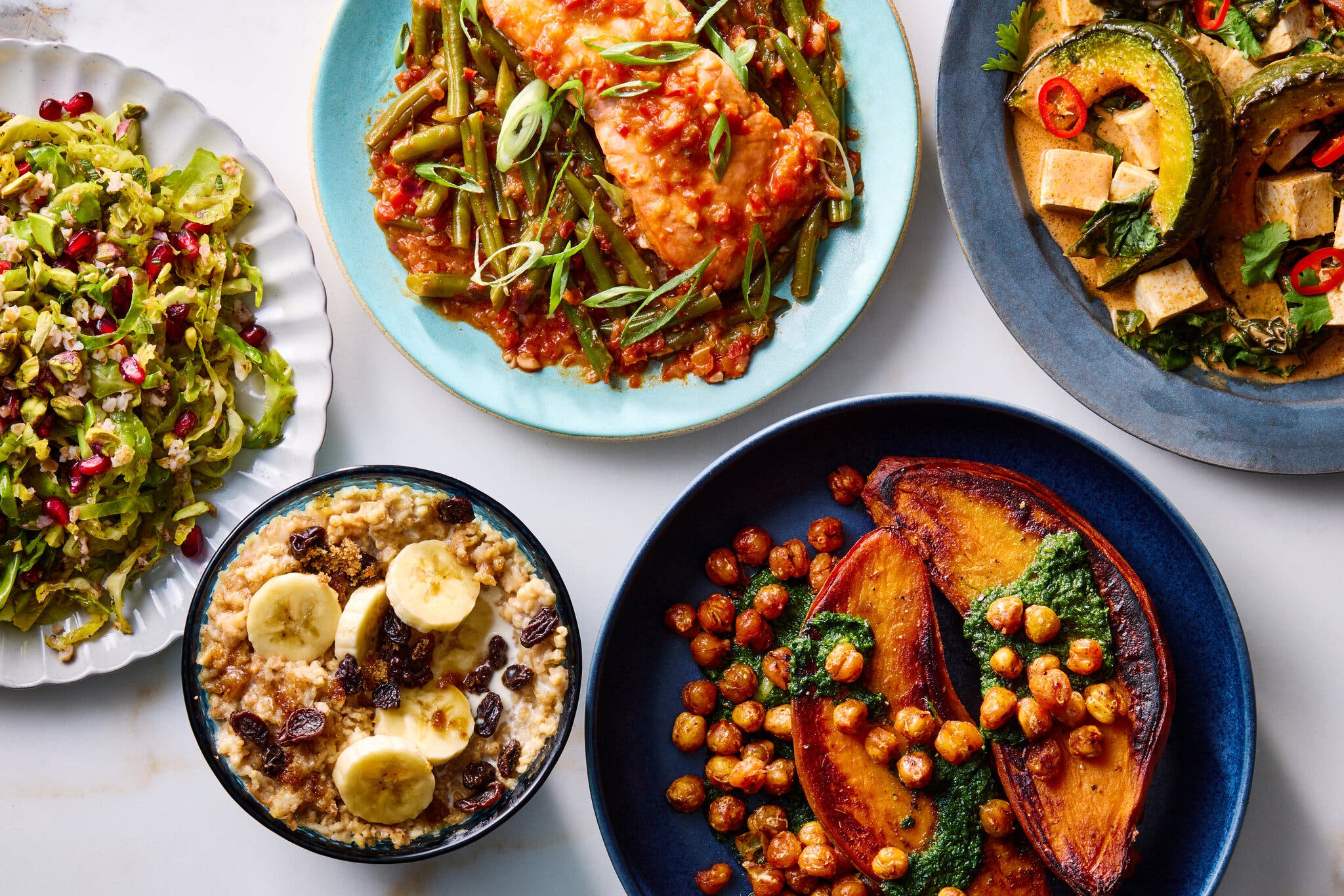 An assortment of dishes, from sweet potatoes to roasted squash to fish and oatmeal.