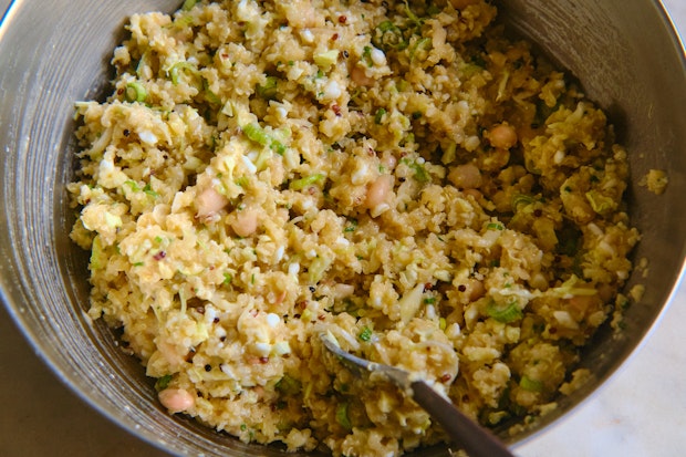 cabbage, beans, quinoa and eggs in a mixing bowl